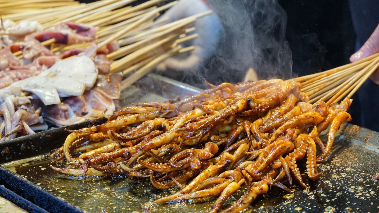 Fried squid skewers on a grill